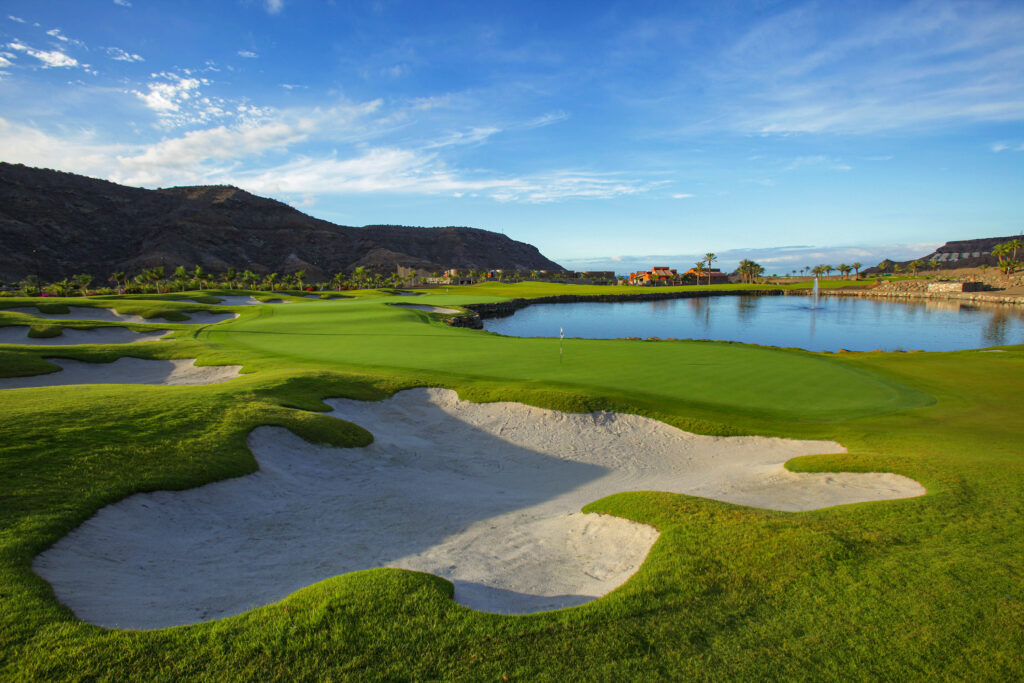 Hole with bunkers and lake with hillside at Anfi Tauro