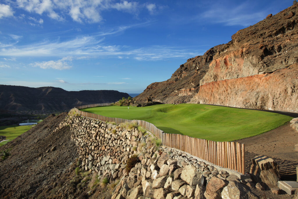 Hole on cliffside with view of course at Anfi Tauro