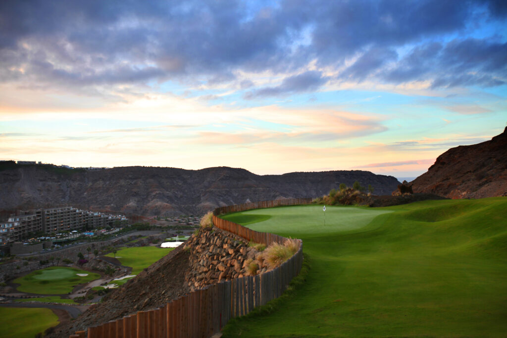 Hole with view of hillsides and building at Anfi Tauro