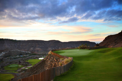 Hole with view of hillsides and building at Anfi Tauro