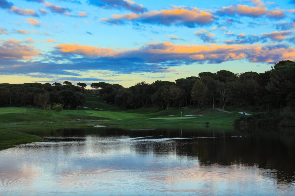 Fairway with lake and trees around at Camiral Golf & Wellness - Stadium Course