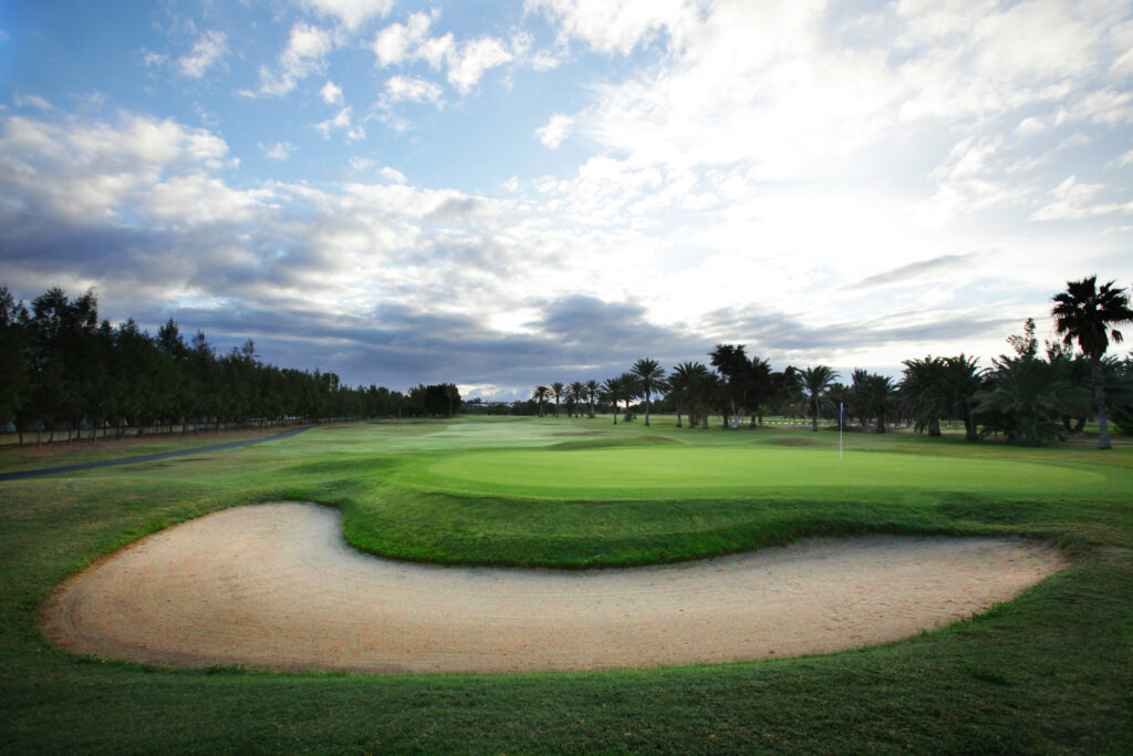 Hole with bunker and trees around at Campo de Golf de Maspalomas