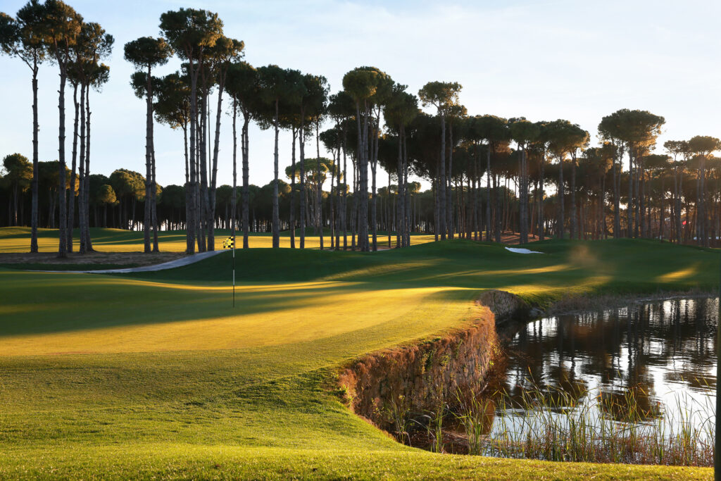 Hole with lake next to it and trees around at Carya Golf Course