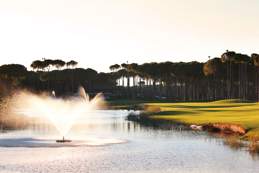 Lake with fountain and trees around at Carya Golf Course