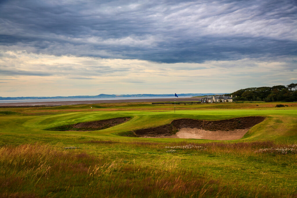 Hole with bunkers at Craigielaw Golf Club with building in distance