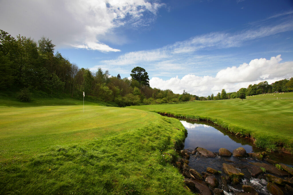 Hole with white flag at Dalmahoy - East Course with stream running next to it