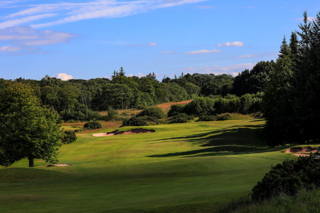 Fairway with bunkers at The Dukes Course with trees around