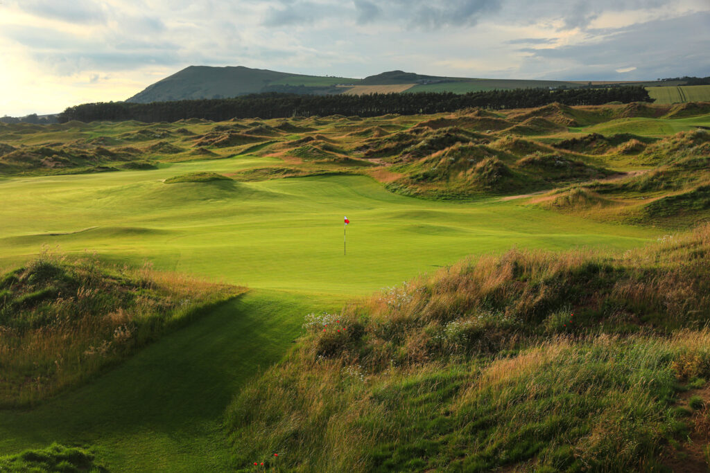 Hole at Dumbarnie Links with hills in background