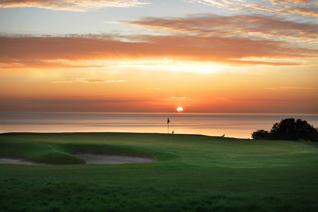 Hole with bunkers at Fairmont St Andrews - Kittocks overlooking the ocean at sunset