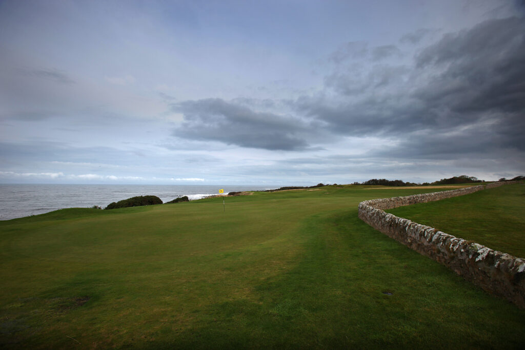 Hole with yellow flag at Fairmont St Andrews - Torrance with ocean view