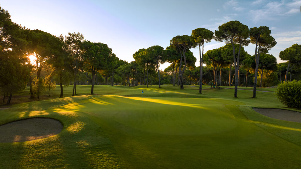 Hole with blue flag with trees around at Gloria - New Golf Course