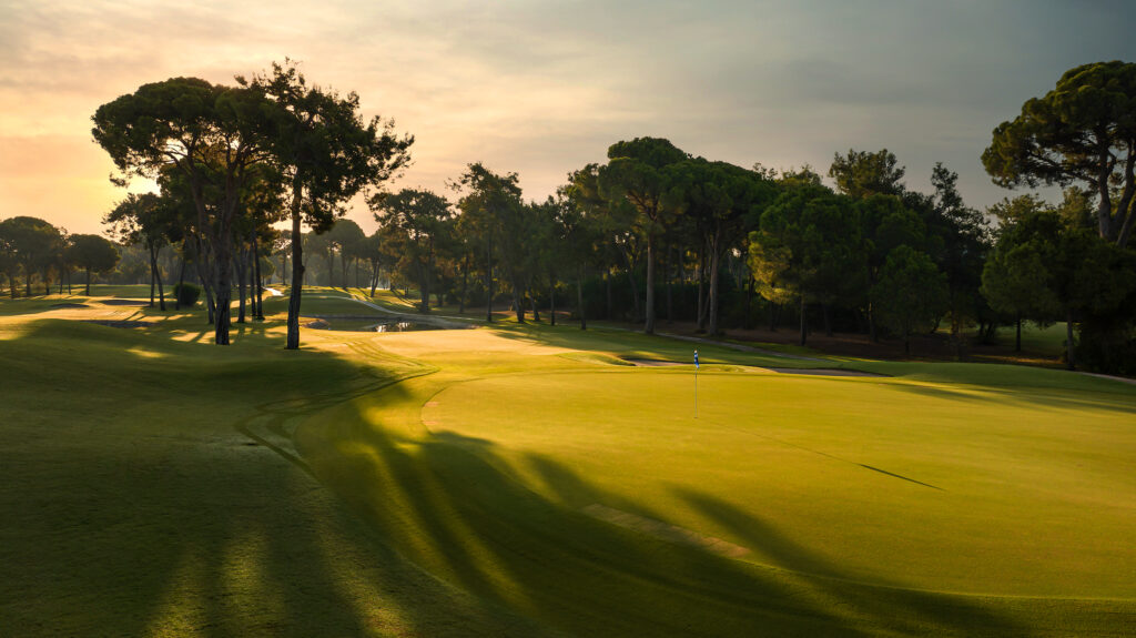 Hole with trees around at sunset at Gloria - New Golf Course