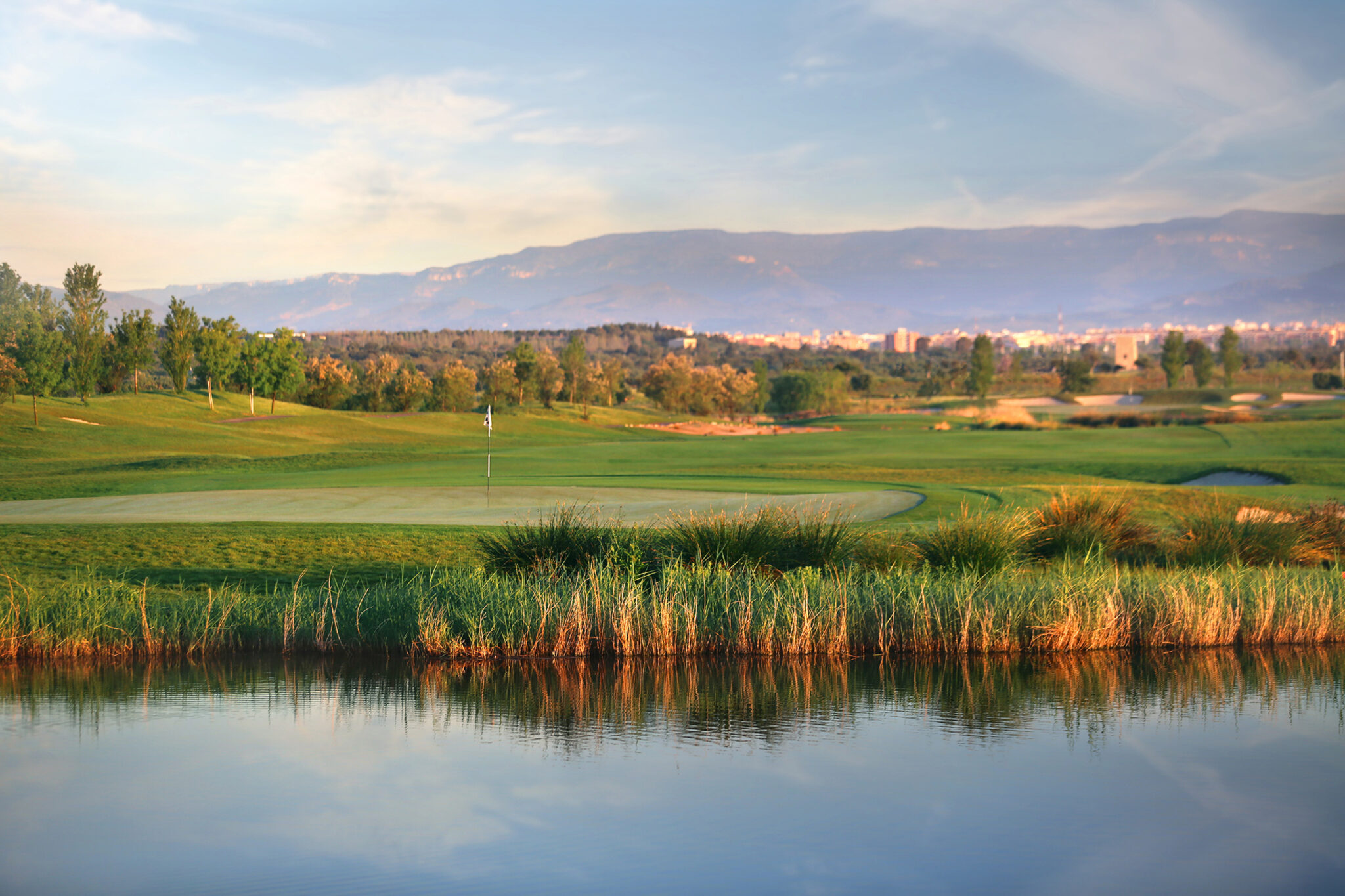 Lake with hole and fairway in background at Infinitum Lakes Course