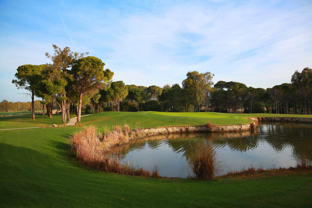 Lake on fairway with trees around at Kaya Palazzo Golf Club