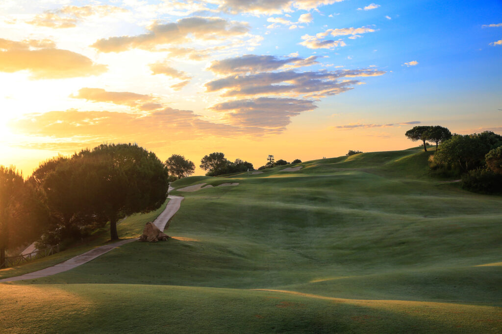 Fairway with bunkers and trees at sunset at La Cala - America Golf Course