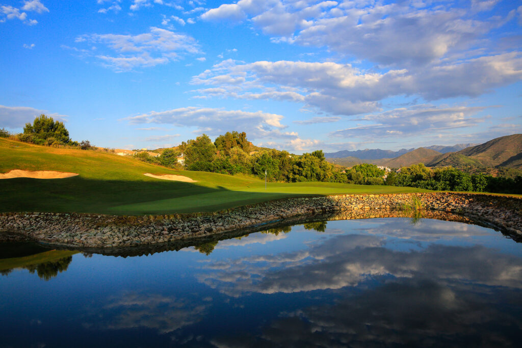 Hole with lake and trees in background at La Cala - America Golf Course