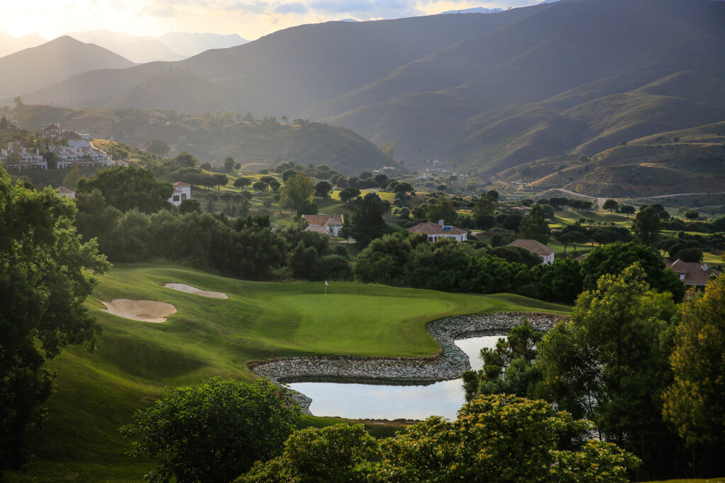 Fairway with lake and bunkers and trees around at La Cala - America Golf Course