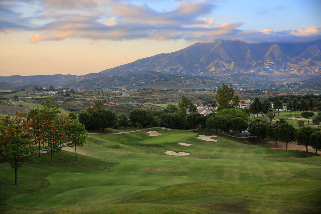 Fairway with bunkers and trees around with mountain in background at La Cala - America Golf Course