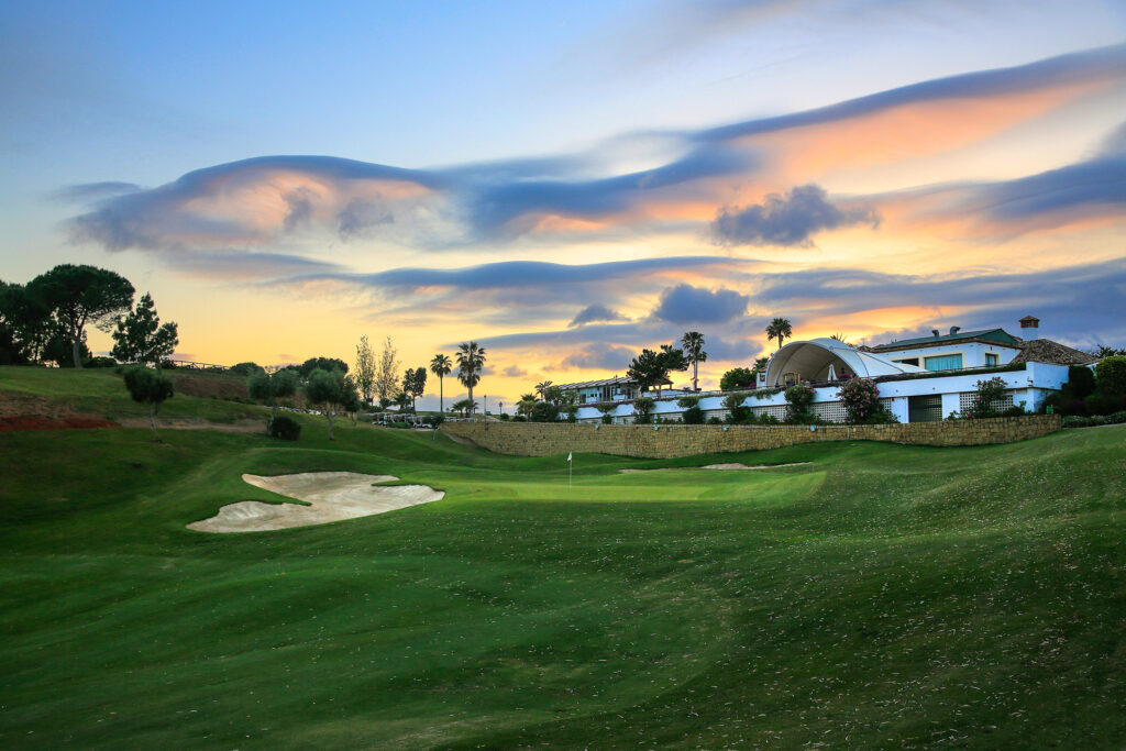 Bunker on fairway near hole at La Cala - Asia Golf Course at sunset