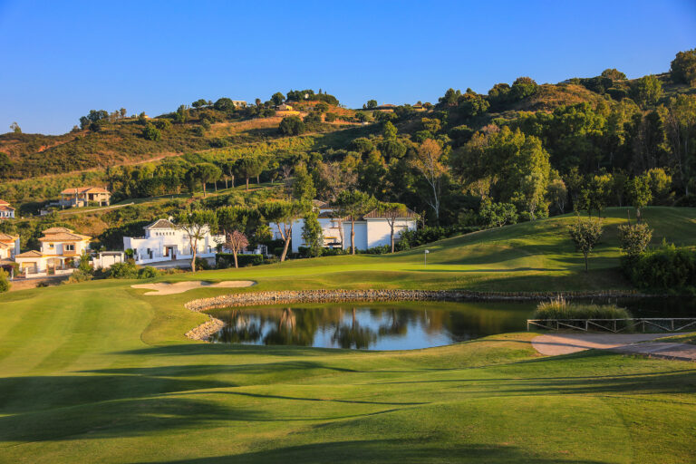 Lake on fairway with bunkers and trees in background at La Cala - Asia Golf Course