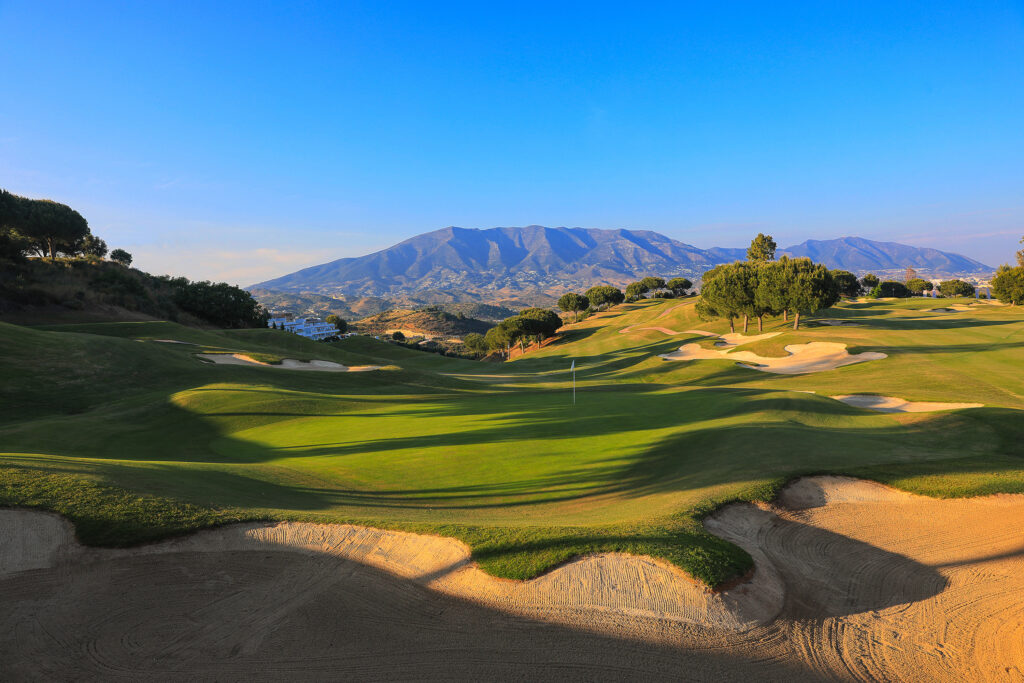 Hole with bunker and mountain in background at La Cala - Asia Golf Course