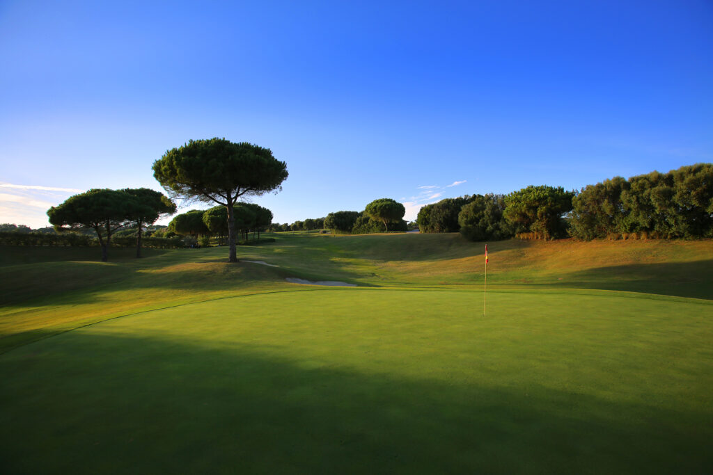 Hole with red and yellow flag at La Reserva de Sotogrande Golf Course