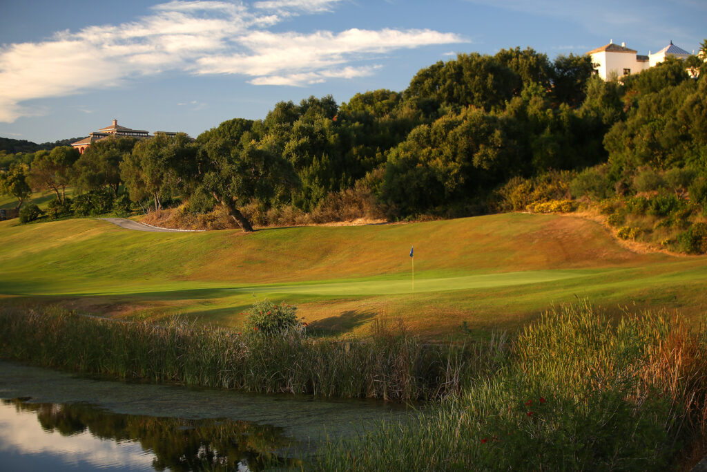 Hole with trees in background at La Reserva de Sotogrande Golf Course