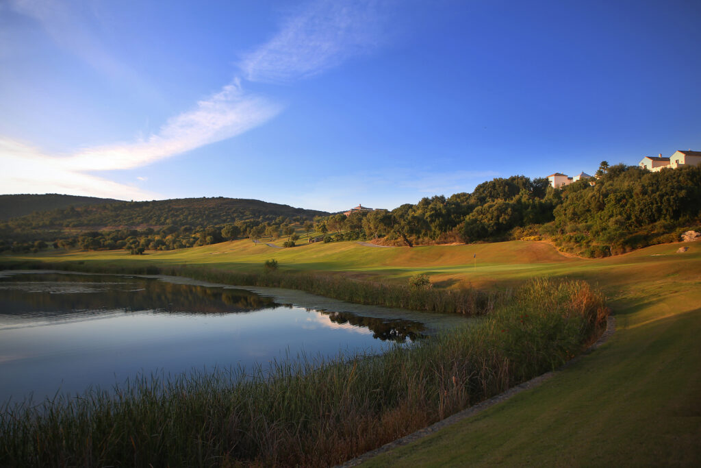 Fairway with lake and trees around at La Reserva de Sotogrande Golf Course