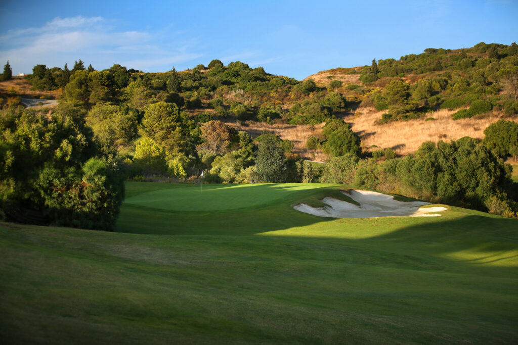 Hole with bunker and trees around at La Reserva de Sotogrande Golf Course