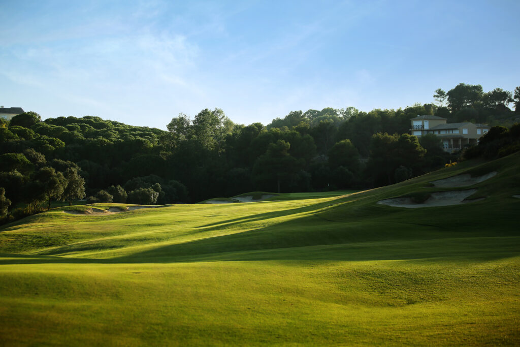 Fairway with bunkers and trees around at La Reserva de Sotogrande Golf Course