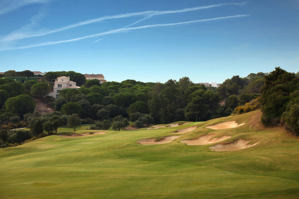 Fairway with bunkers and trees around at La Reserva de Sotogrande Golf Course