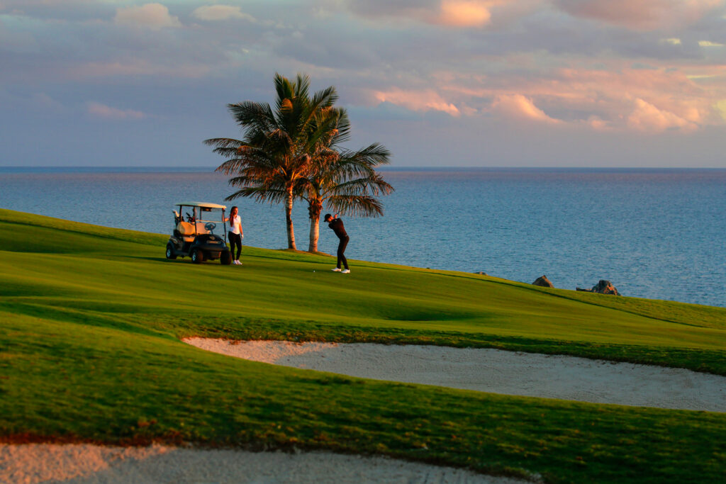 People playing golf at Meloneras Golf at sunset