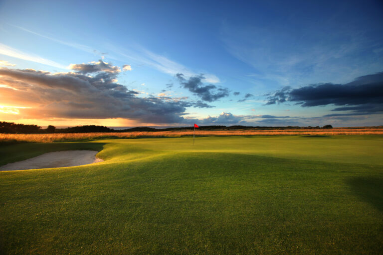 Hole with red flag with bunker at Muirfield