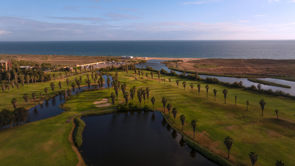 Fairway with ocean in background with palm trees and lakes at Salgados Golf Course