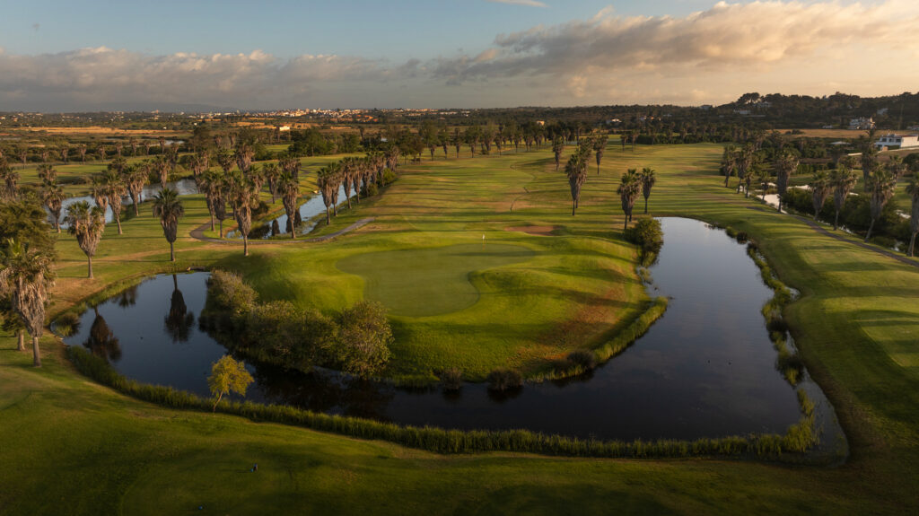 Fairway with water hazards and palm trees at Salgados Golf Course