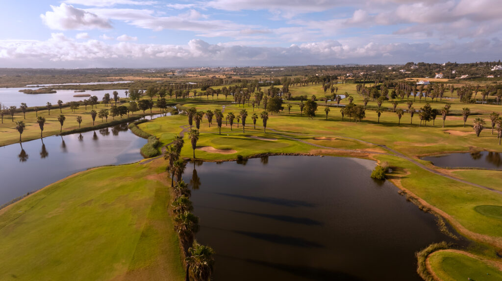 Fairway with lakes and palm trees at Salgados Golf Course