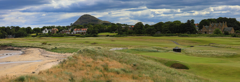 Panoramic view of North Berwick Golf Club with buildings and hills in background