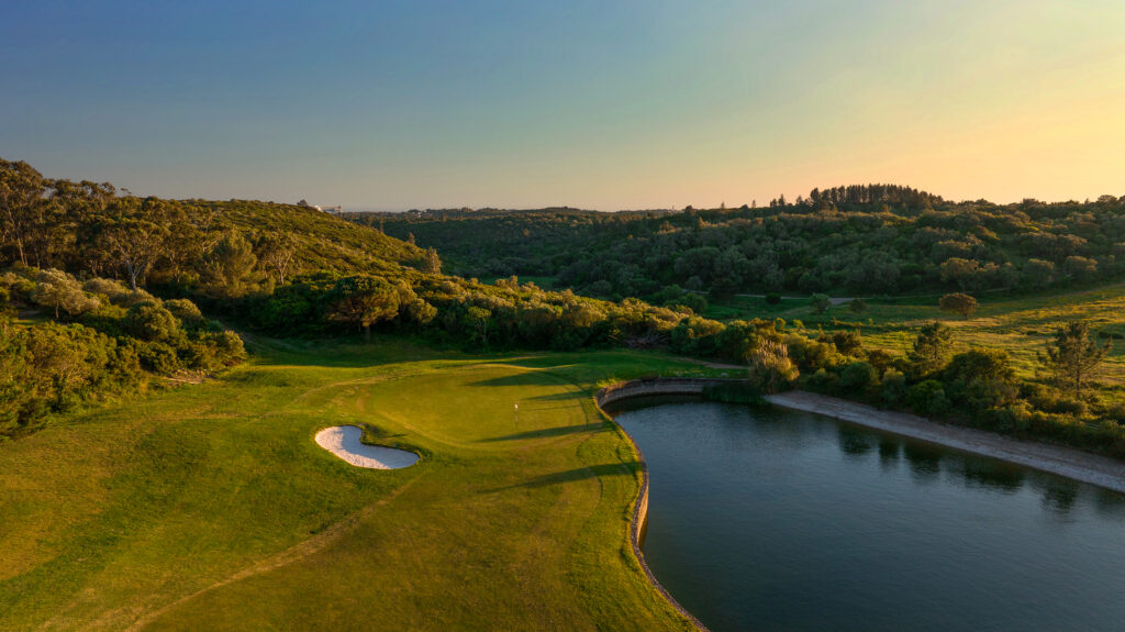 Hole with bunker and a lake and trees around it at Penha Longa Atlantic Course