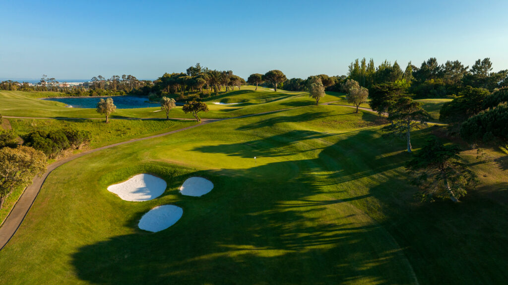 Aerial view of the fairway and a hole with bunkers at Penha Longa Atlantic Course