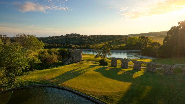 Hole with castle ruins and lake in background at Penha Longa Atlantic Course