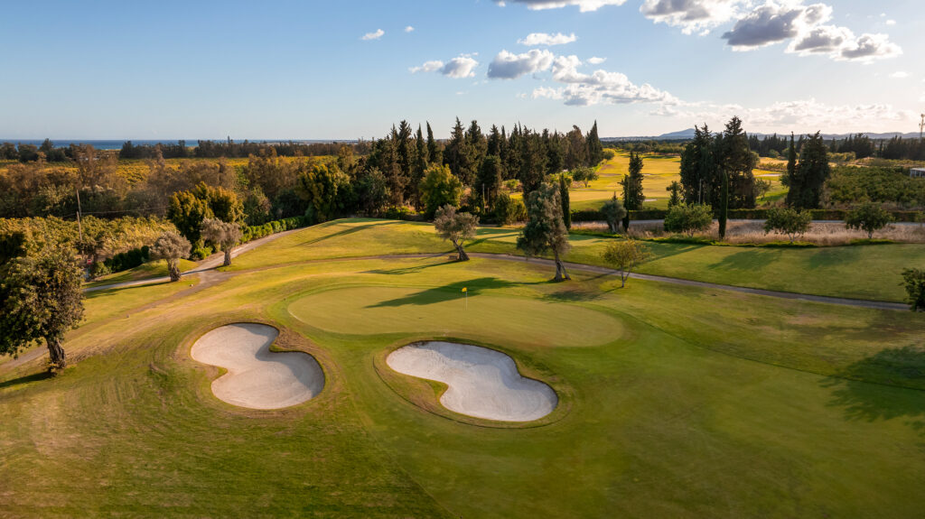 A green with bunkers next to it and trees in background at Quinta De Cima Golf Course