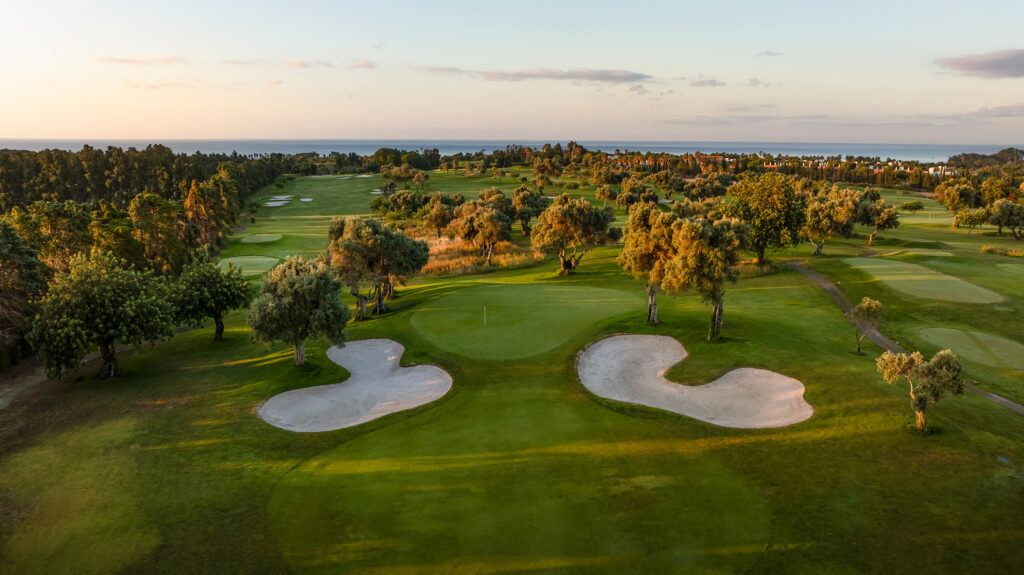 A green with bunkers and trees around it at Quinta De Cima Golf Course