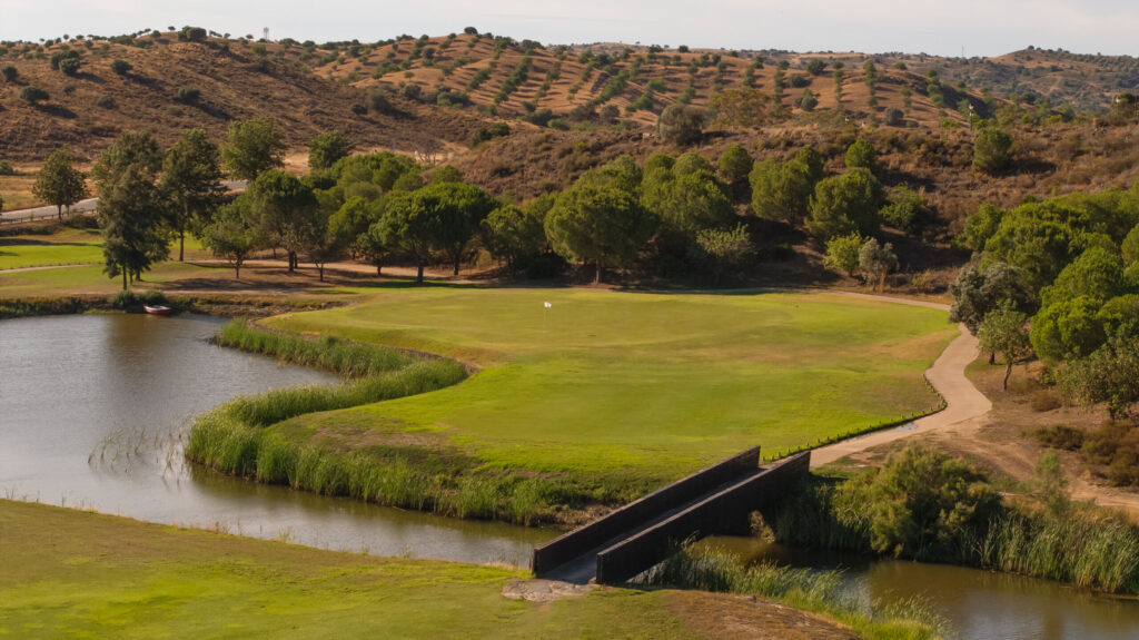 Bridge over a lake leading to a green at Quinta do Vale Golf Course