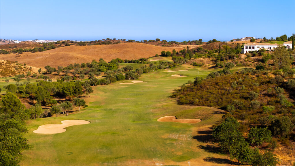 A fairway with bunkers and trees around at Quinta do Vale Golf Course