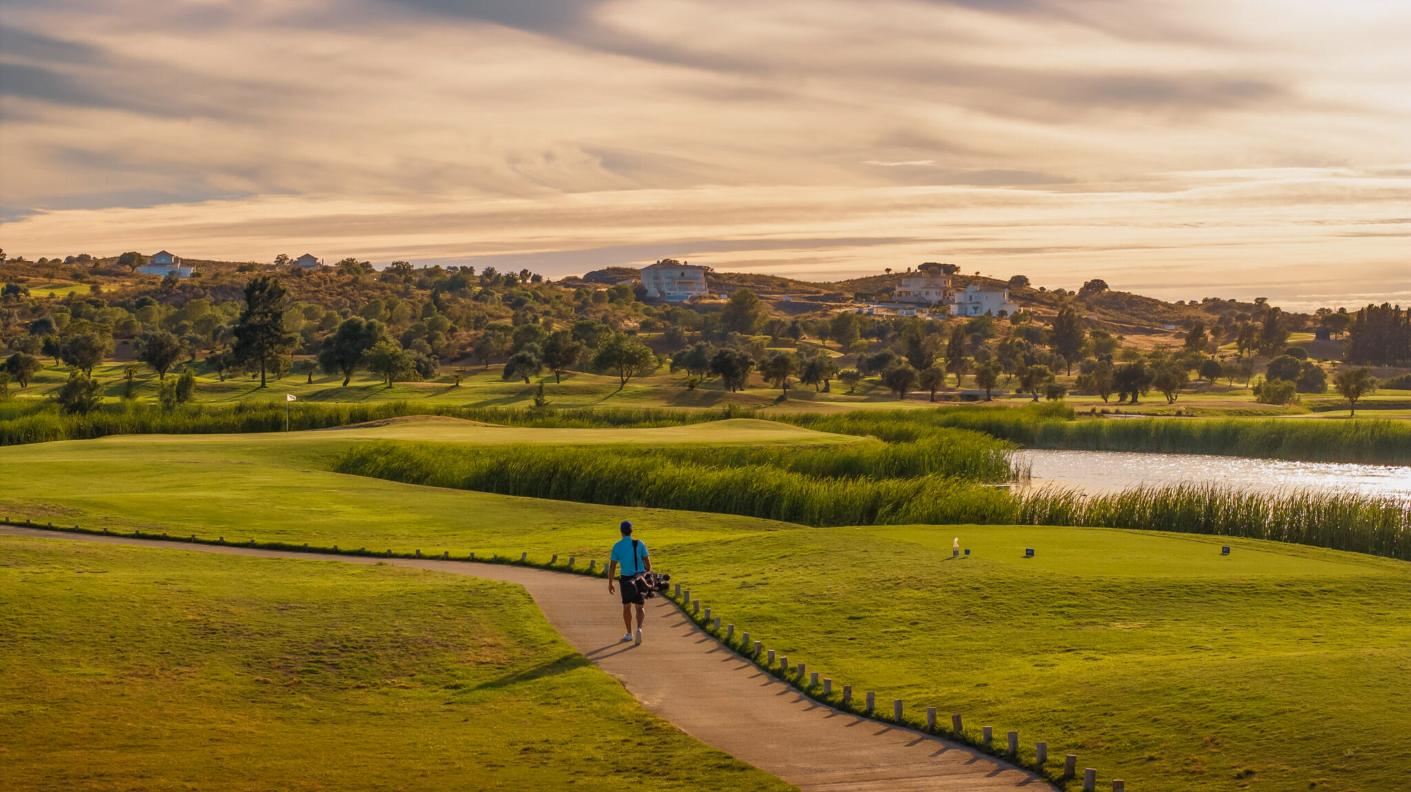 Man carrying clubs through Quinta do Vale Golf Course