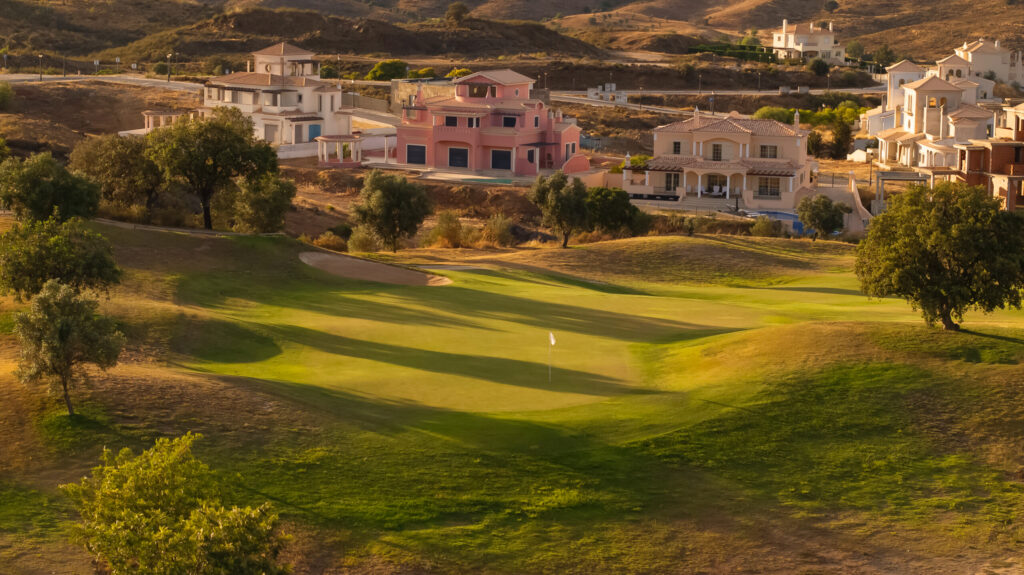 A green at Quinta do Vale Golf Course with villas in background