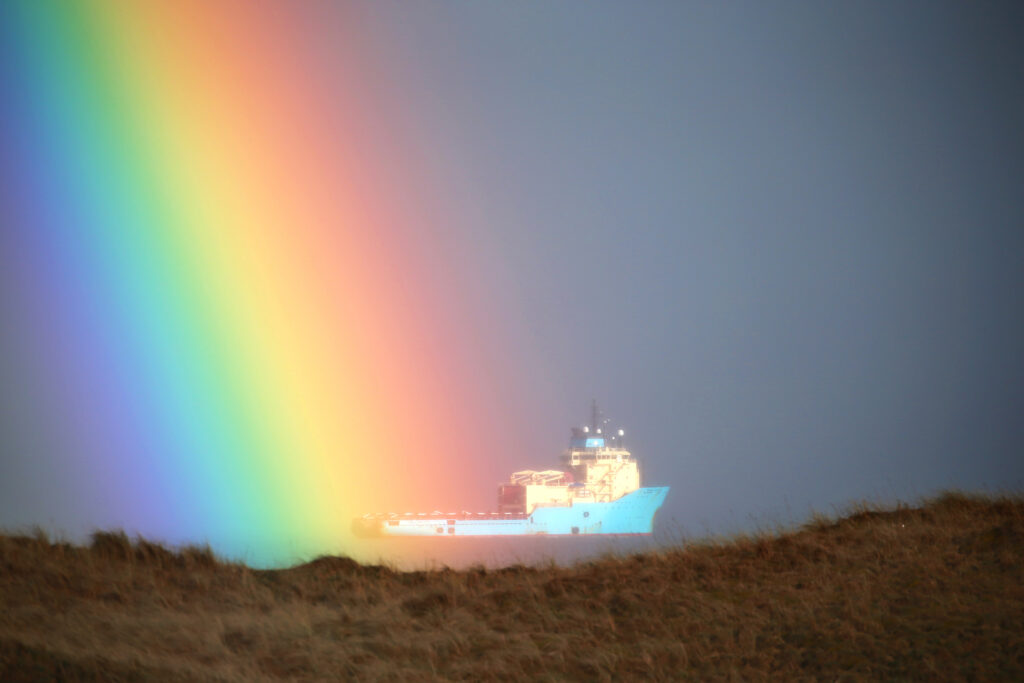 Ship with rainbow in foreground at Balgownie Links at Royal Aberdeen Golf Club