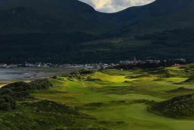 Fairway at Annesley Links at Royal County Down with buildings and hills in background