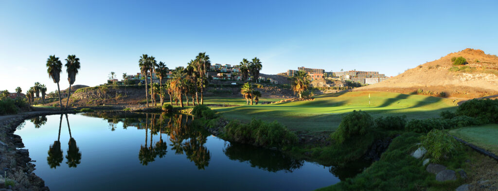 A hole at Salobre Golf - Old Course with lake and trees around