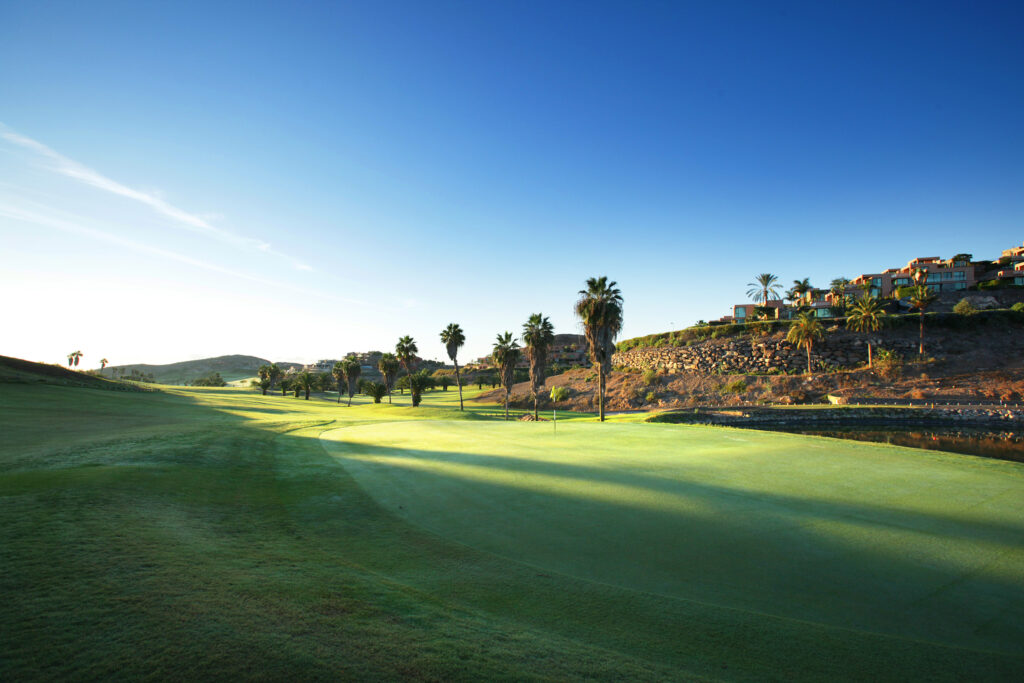 Hole with trees around and buildings in background at Salobre Golf - Old Course